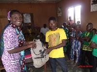 SISTER SALOMI EDOH THE CONDINATOR OF THE ROYAL KIDS PRESENTING THE BACK TO SCHOOL PACK.